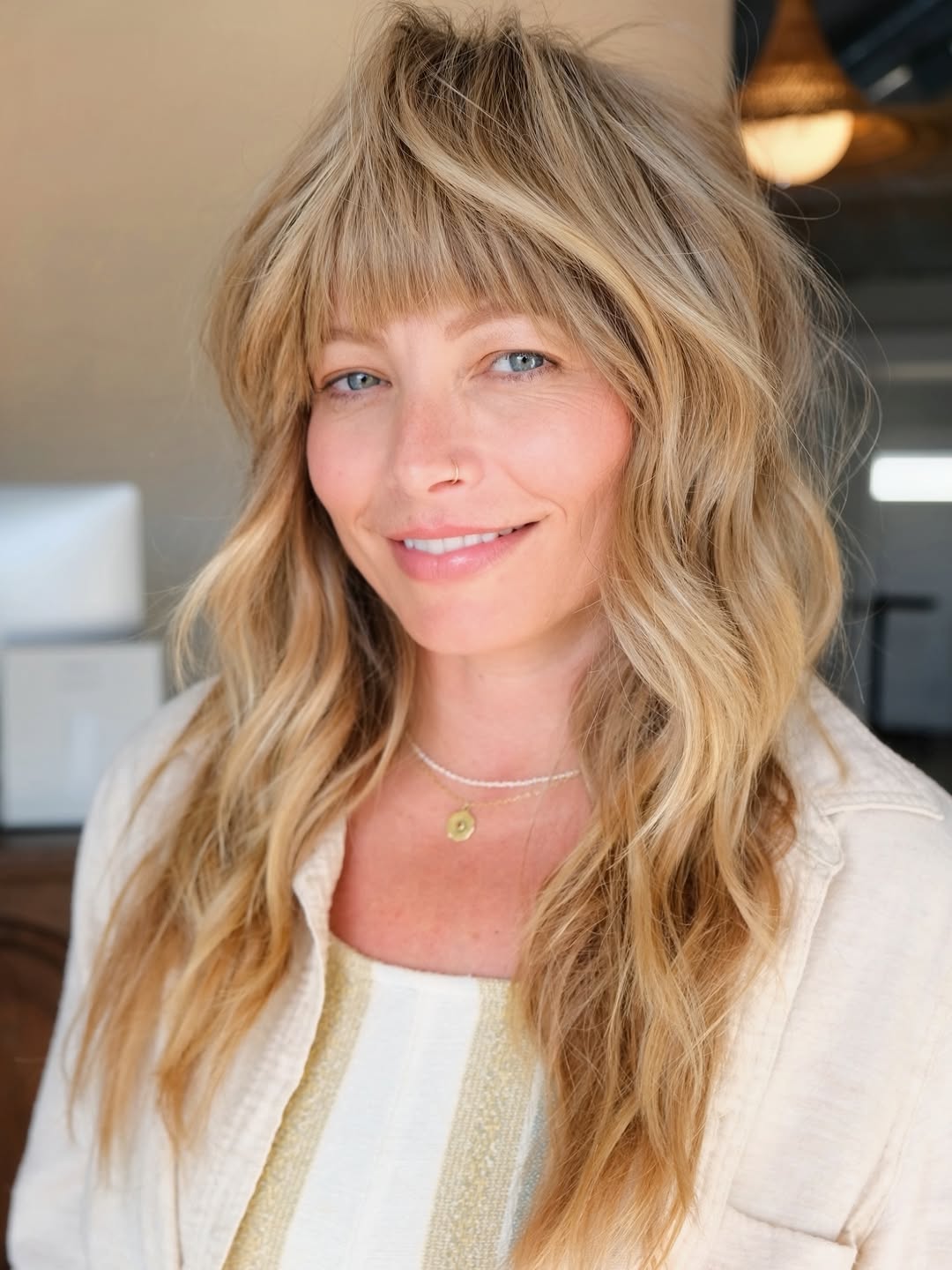 Voluminous Blonde Shag Haircut with Soft Curtain Bangs and Waves