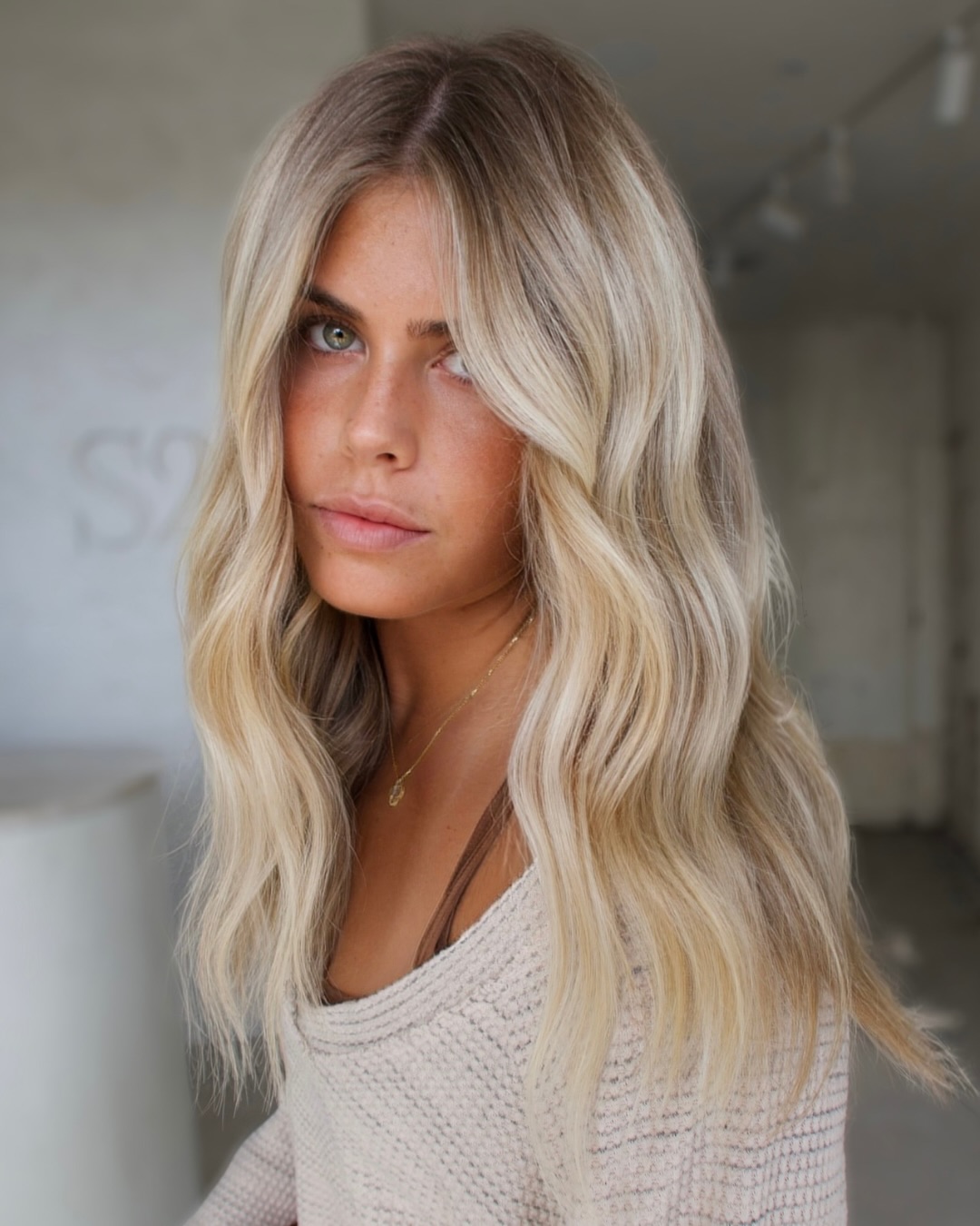 Creamy Blonde Hair with a Soft Shadow Root vs a Distinct Root Smudge Effect