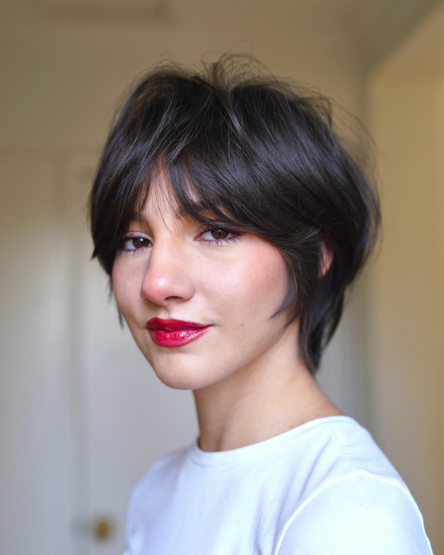 Wispy Bixie Cut With Curtain Bangs on a Round Face