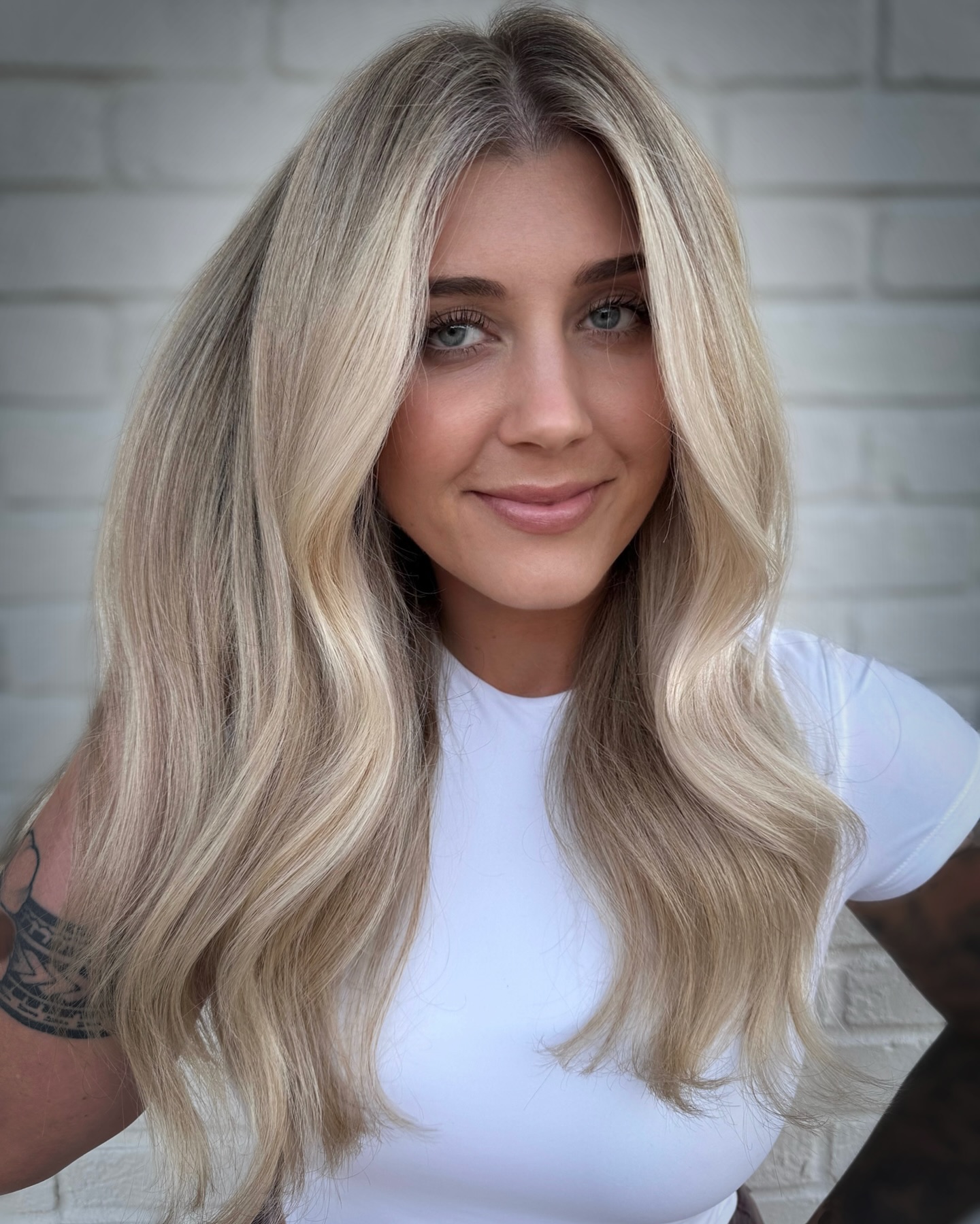 Bright Platinum Blonde Waves with a Subtle Shadow Root Showing What the Technique Actually Is