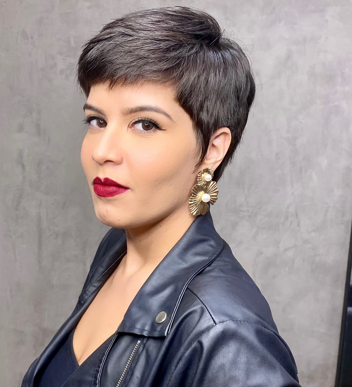 Side-Swept Dark Pixie Haircut with Clean Tapered Sides on a Round Face