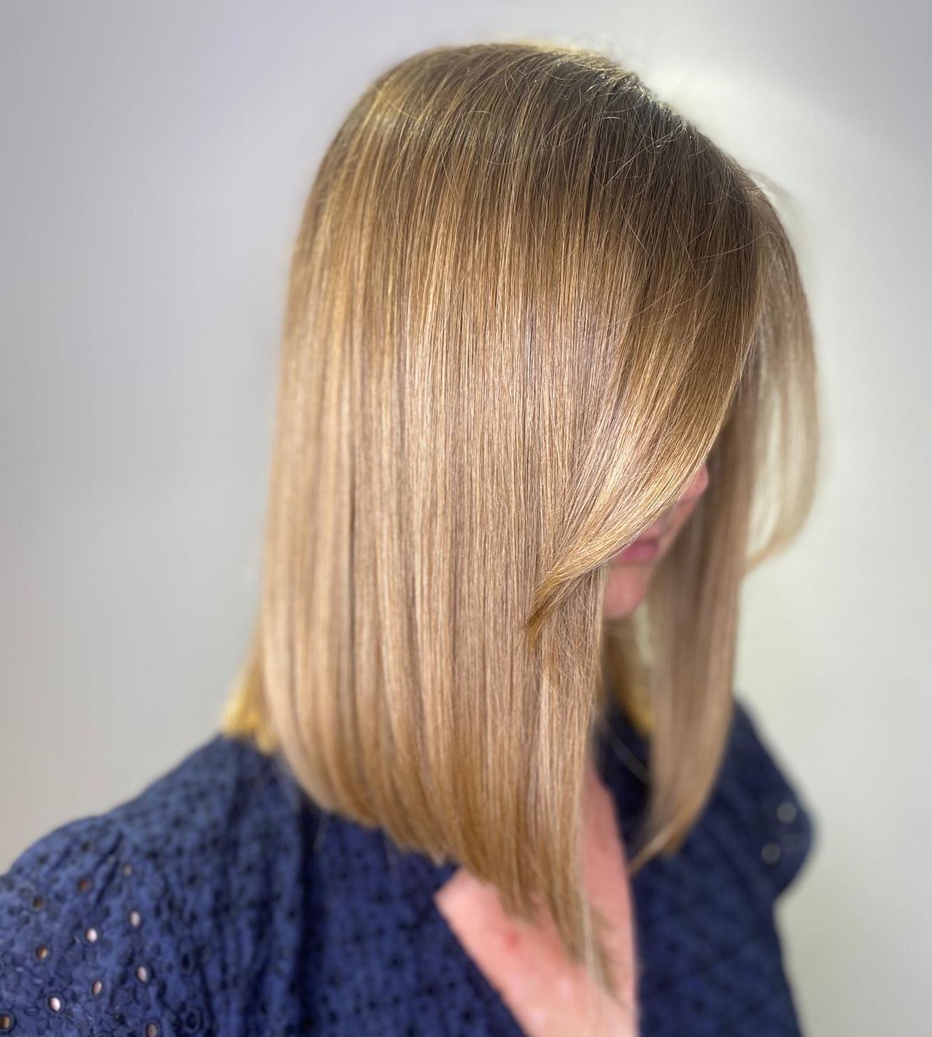 Sleek Straight Caramel Blonde Long Bob Haircut Profile View