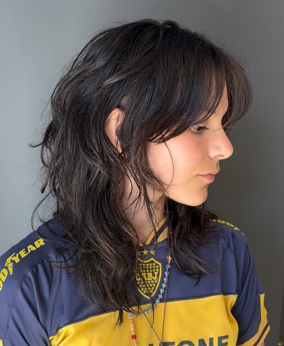 Side Profile of a Brunette Wolf Cut with Wispy Face-Framing Layers