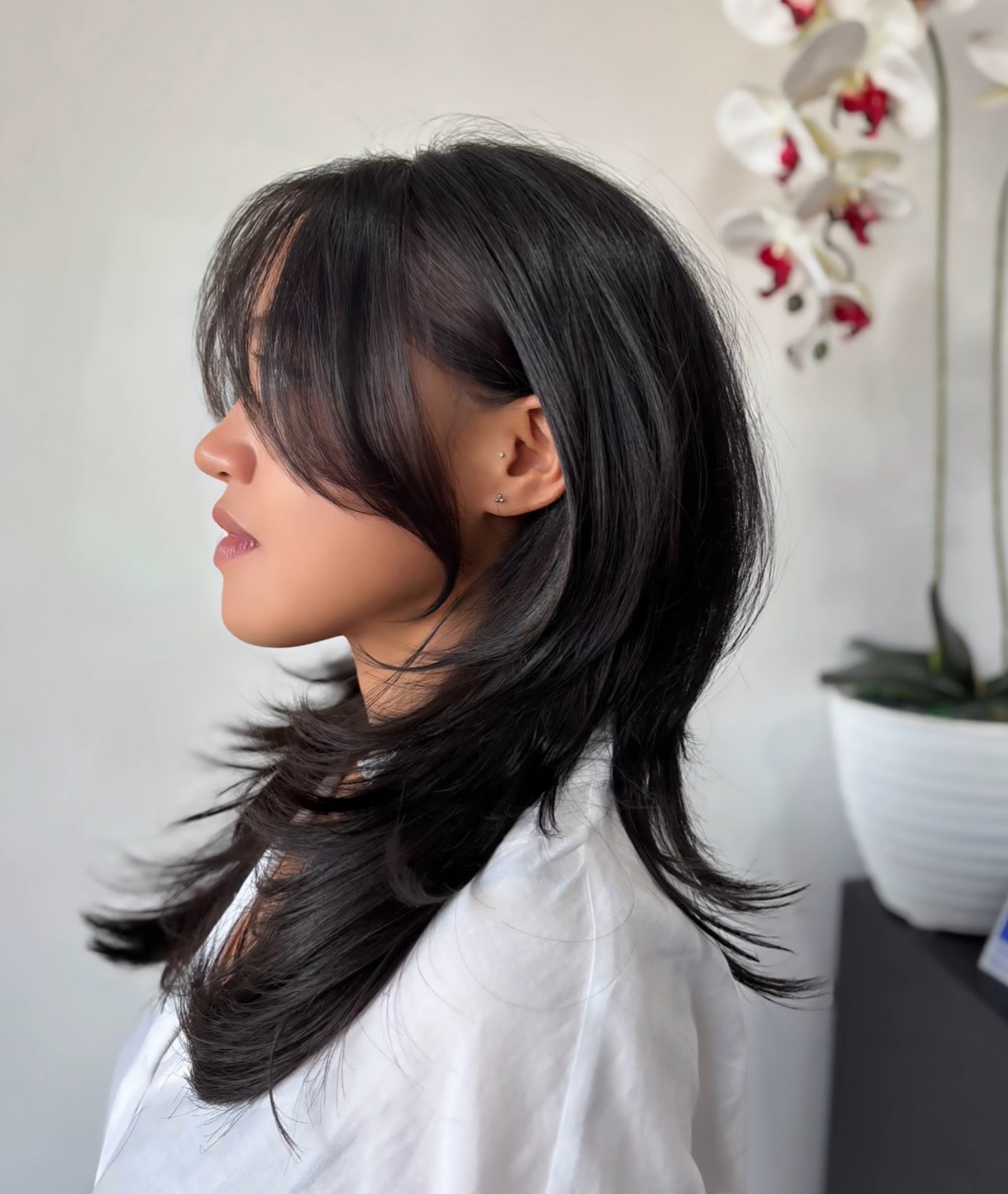 Layered Black Hush Cut or Jellyfish Haircut with Wispy Framing Fringe Side Profile