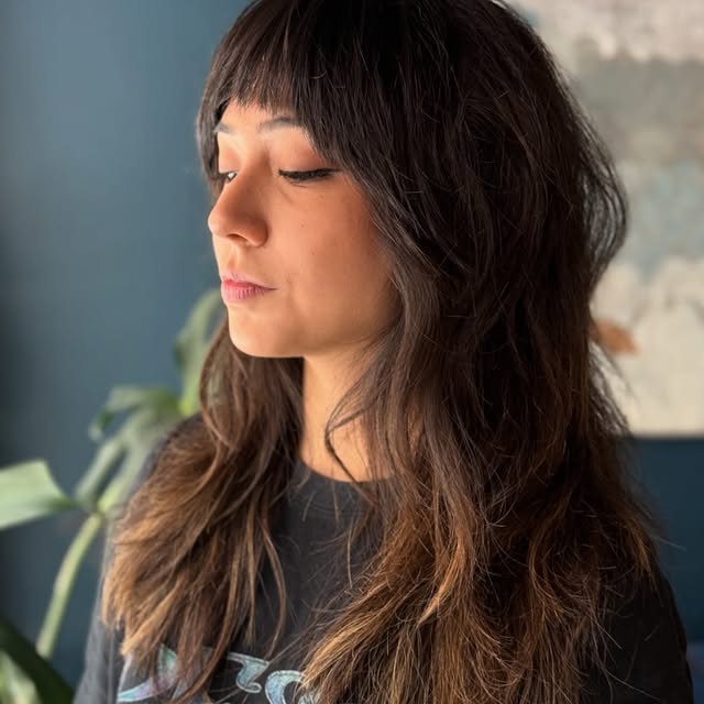 Long Dark Shag Haircut with Thick Classic Bangs
