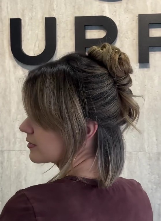 Ash Brown Bob with Soft Face-Framing Bangs and a Messy Half-Up Top Knot Bun