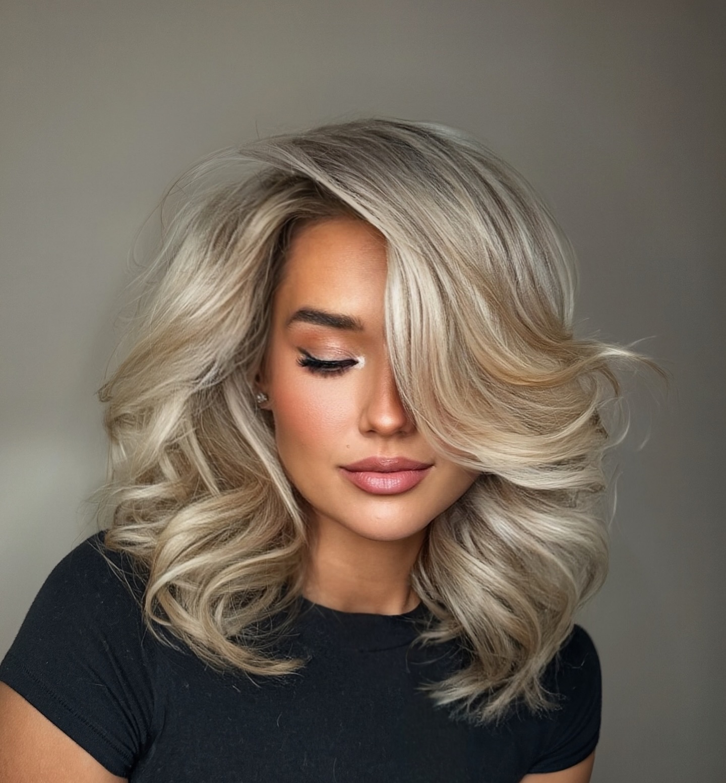 Glamorous Bouncy Ash Blonde Blowout with Deep Side Part and Dramatic Volume