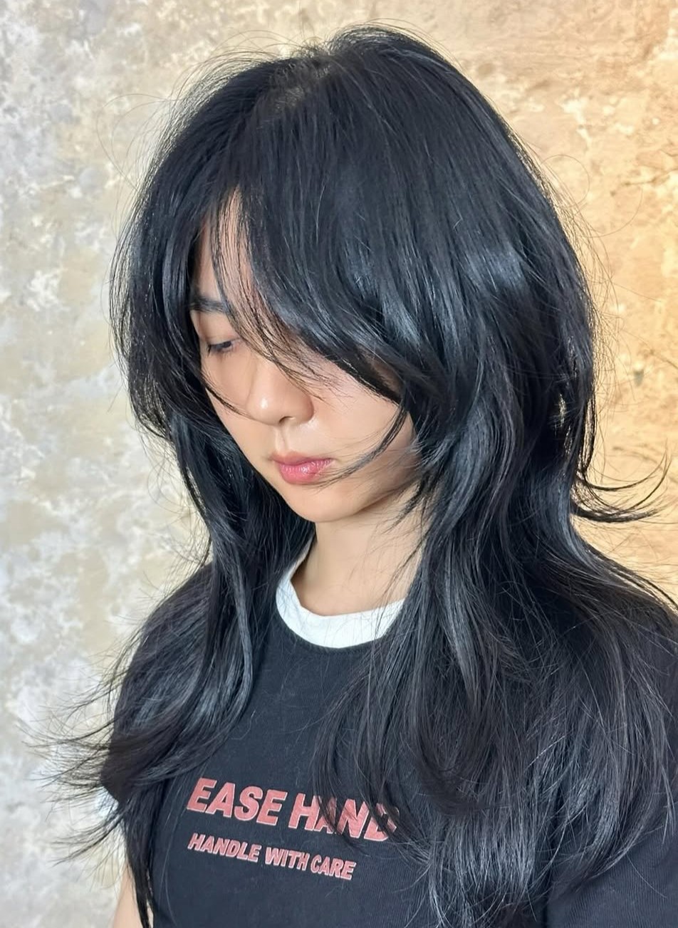 Sleek Black Wolf Cut with Wispy Layers and Soft Framing