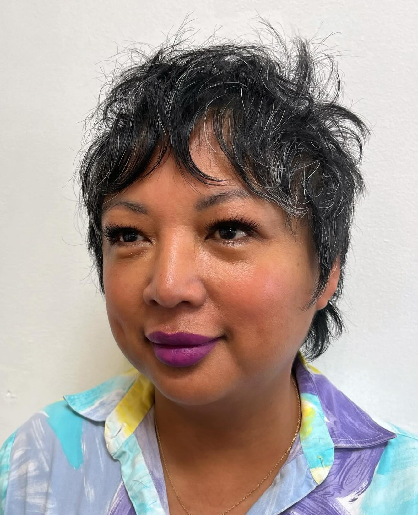 Spiky Salt and Pepper Pixie Hair with Messy Texture and Purple Lipstick