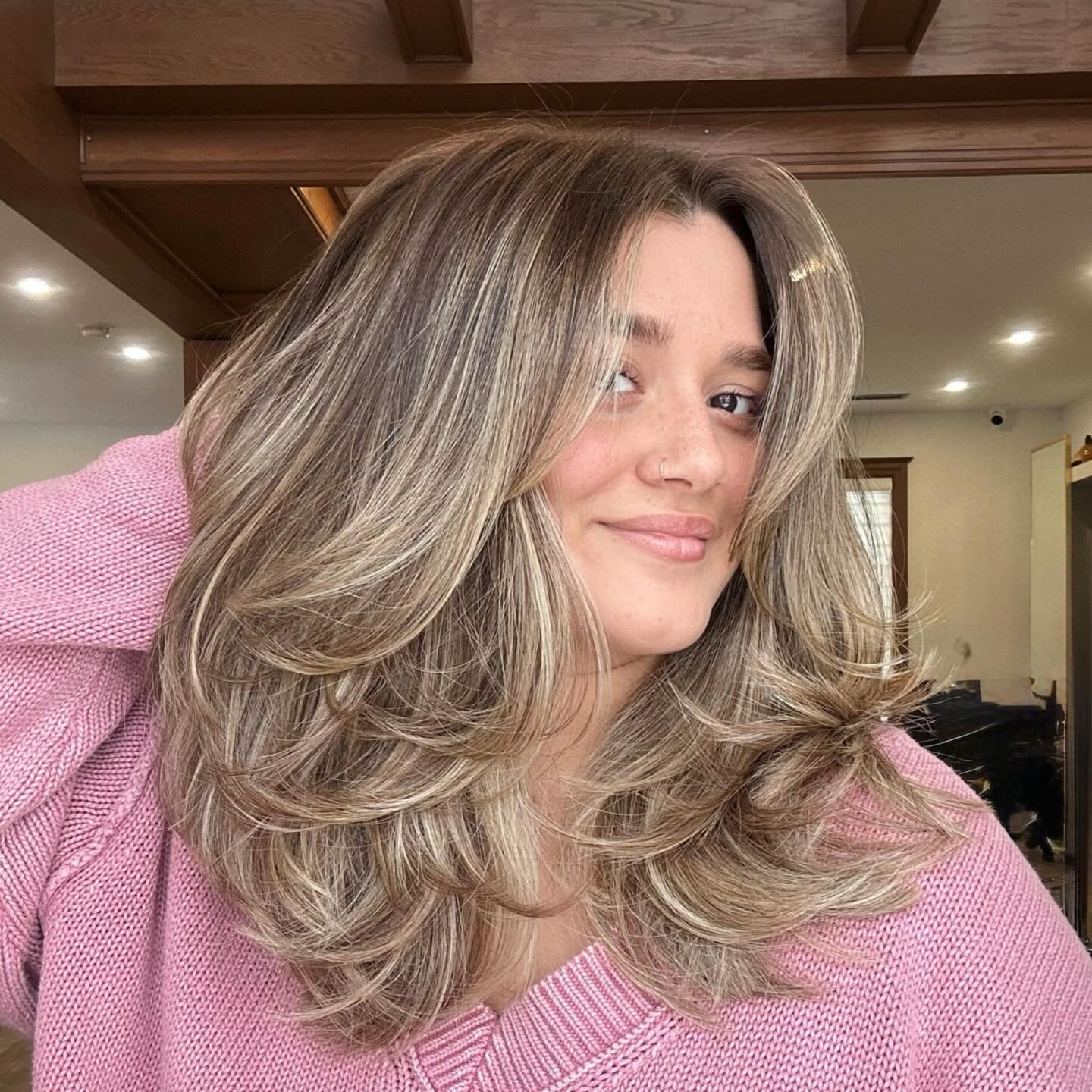 Layered Warm Blonde Voluminous Blowout Haircut with Dimensional Highlights