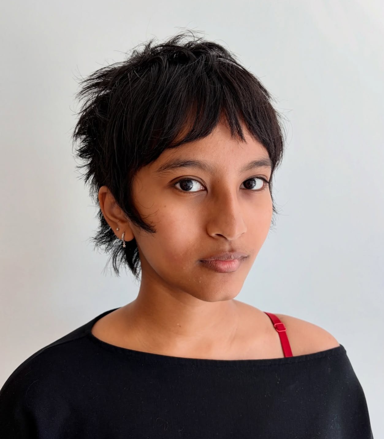 Shaggy Dark Pixie Cut with Choppy Tapered Layers Shown from Three-Quarter Angle