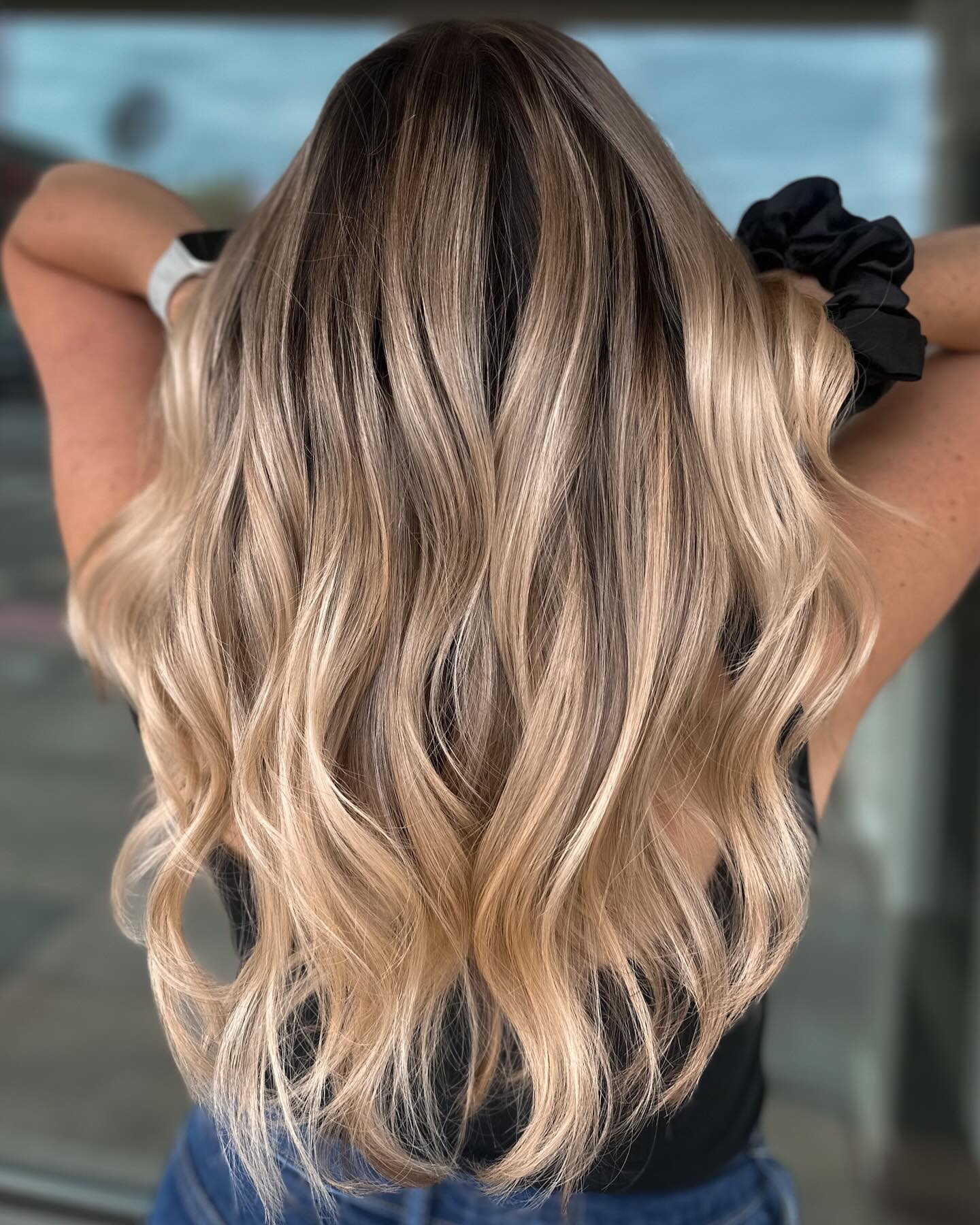 Back View of Long Wavy Blonde Hair Explaining How the Shadow Root Technique Works in the Salon