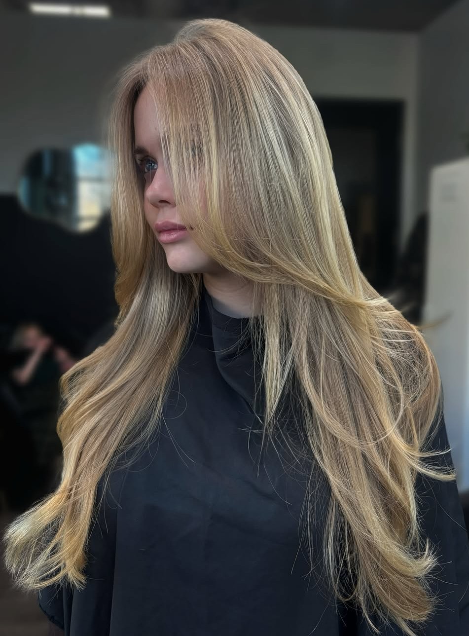 Golden Blonde Layered Hair Styled into Soft Waves