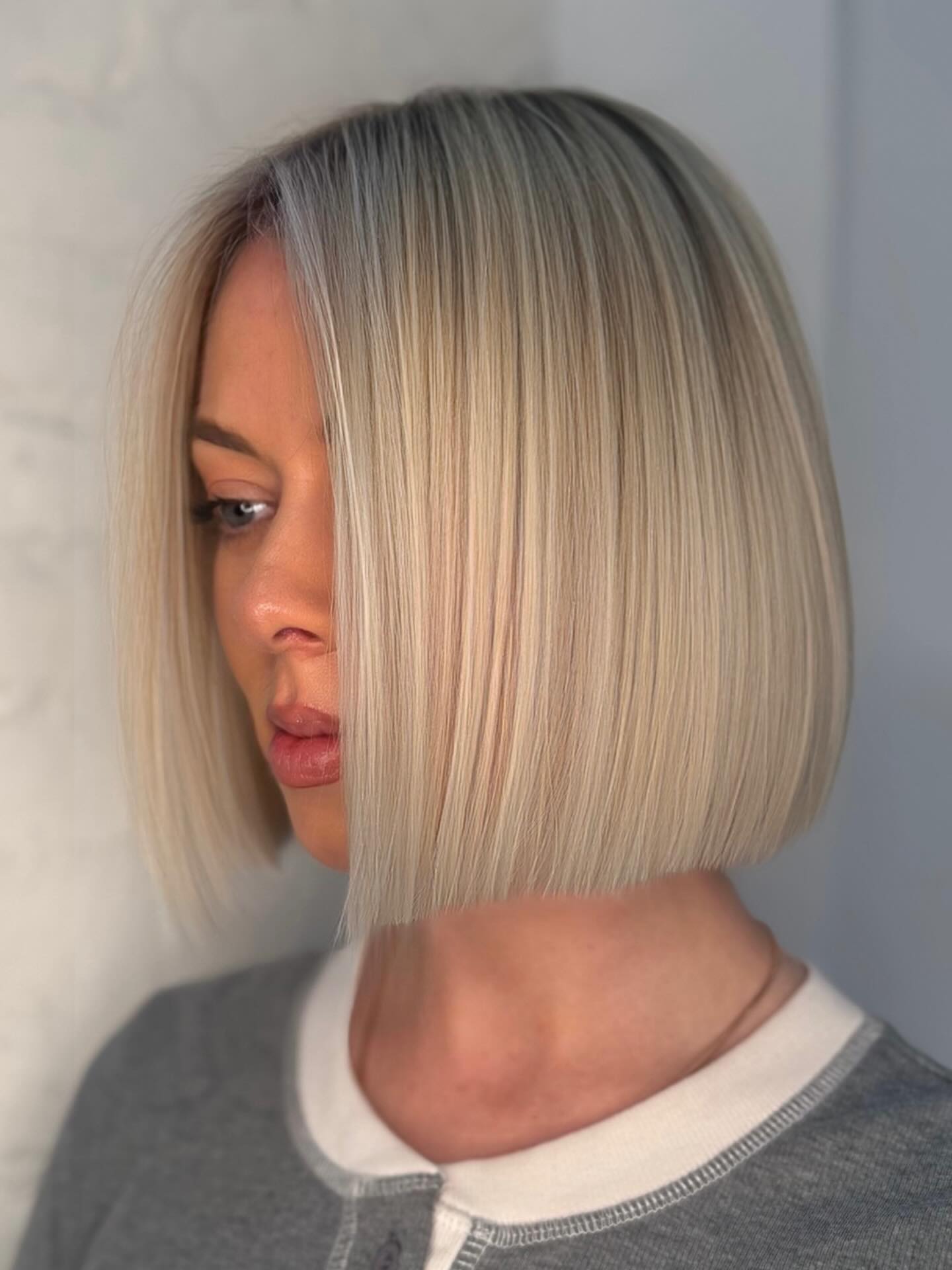 Sleek Straight Platinum Blonde Blunt Bob with Precise Sharp Edges Profile View