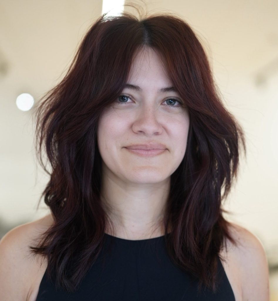 Modern Shag Haircut with Textured Layers and Curtain Bangs on Medium Wavy Hair
