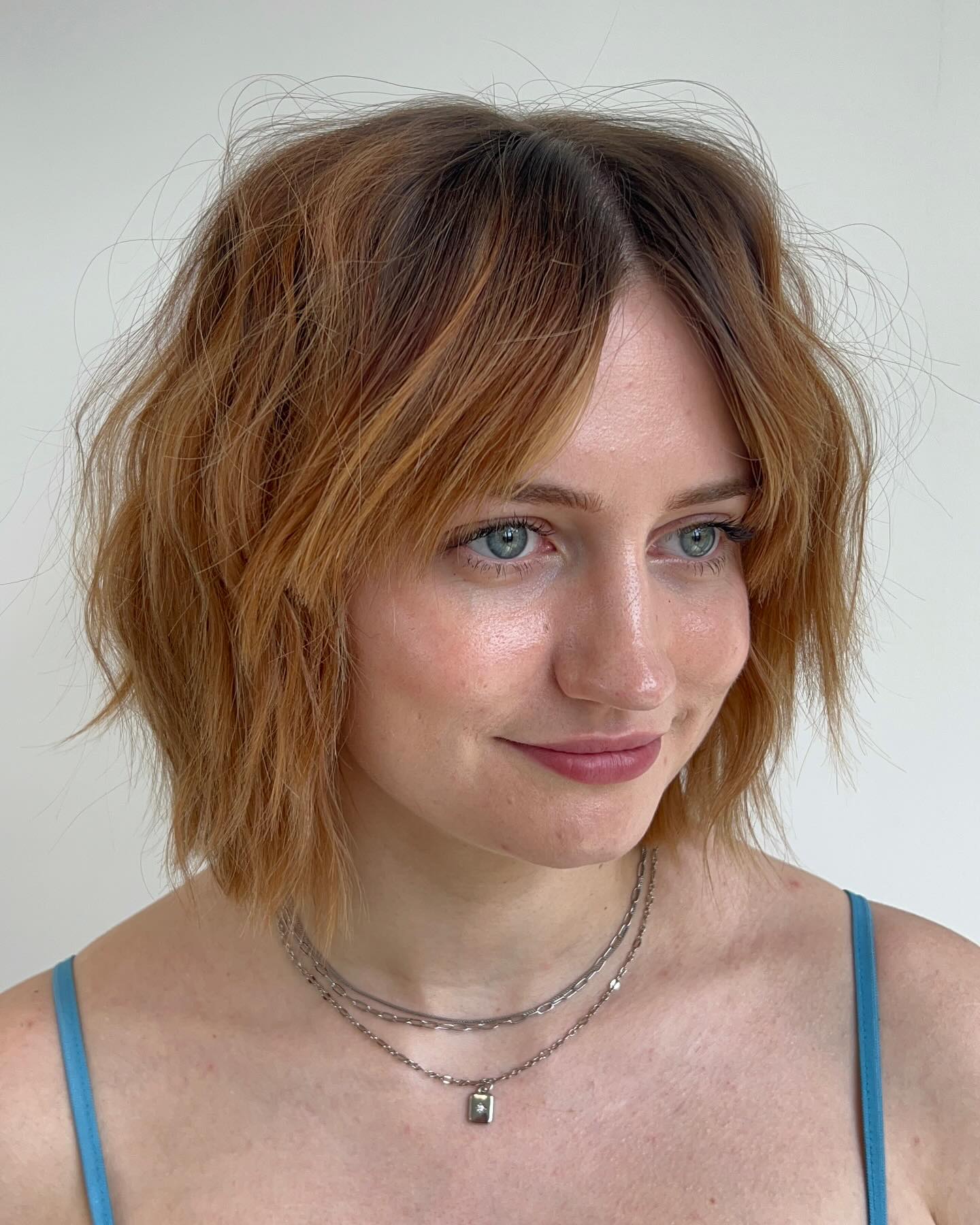 Messy Shaggy Honey Ginger Bob with Point-Cut Textured Ends and Wispy Curtain Bangs