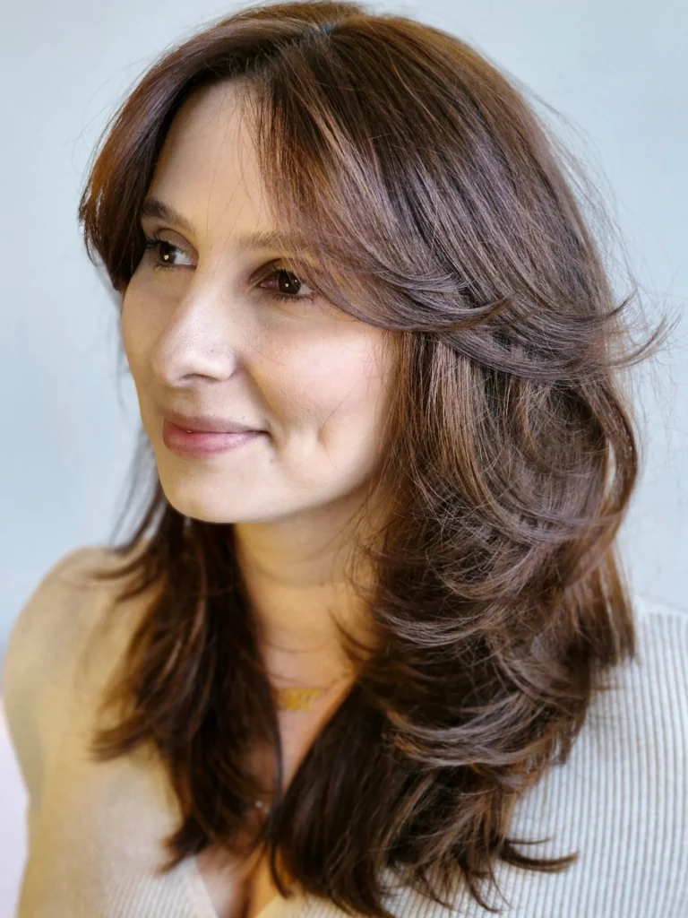 Butterfly Haircut with Curtain Bangs Framing the Face on Medium-Thick Hair