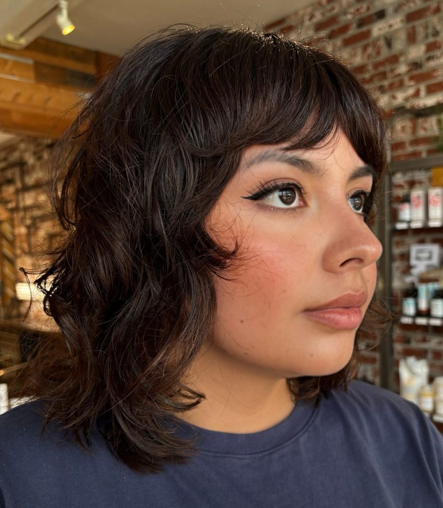 Shoulder-Length Medium Shag Haircut with Face-Framing Layers on Wavy Hair