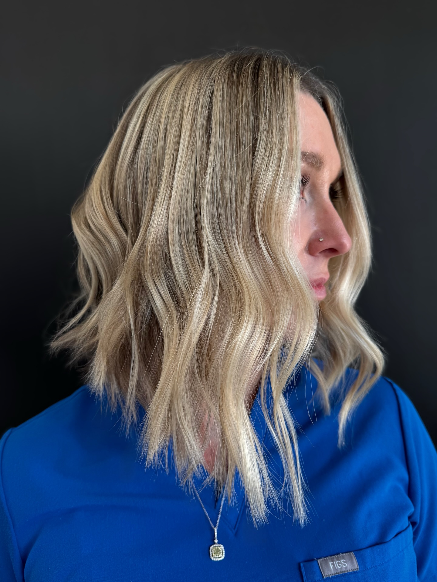 Wavy Angled A-Line Blonde Bob Haircut with Textured Layers Side Profile