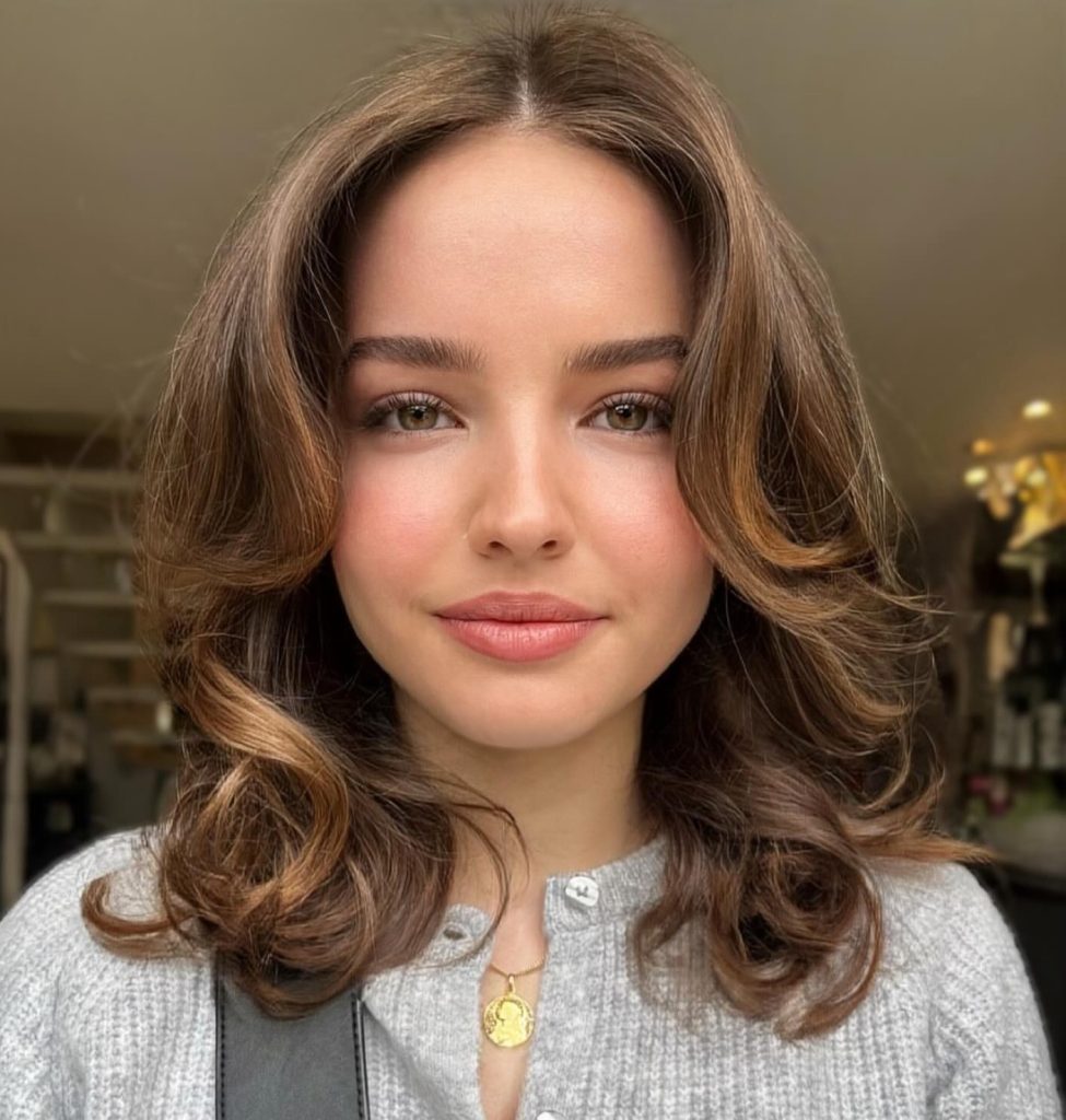Medium-Length Butterfly Haircut at Shoulder Level with Layered Volume on Wavy Hair