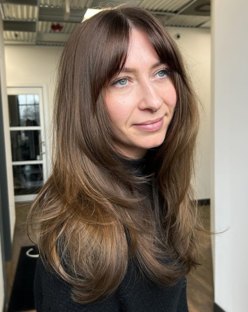Long Layered Hair with Curtain Bangs Blending into Face-Framing Pieces