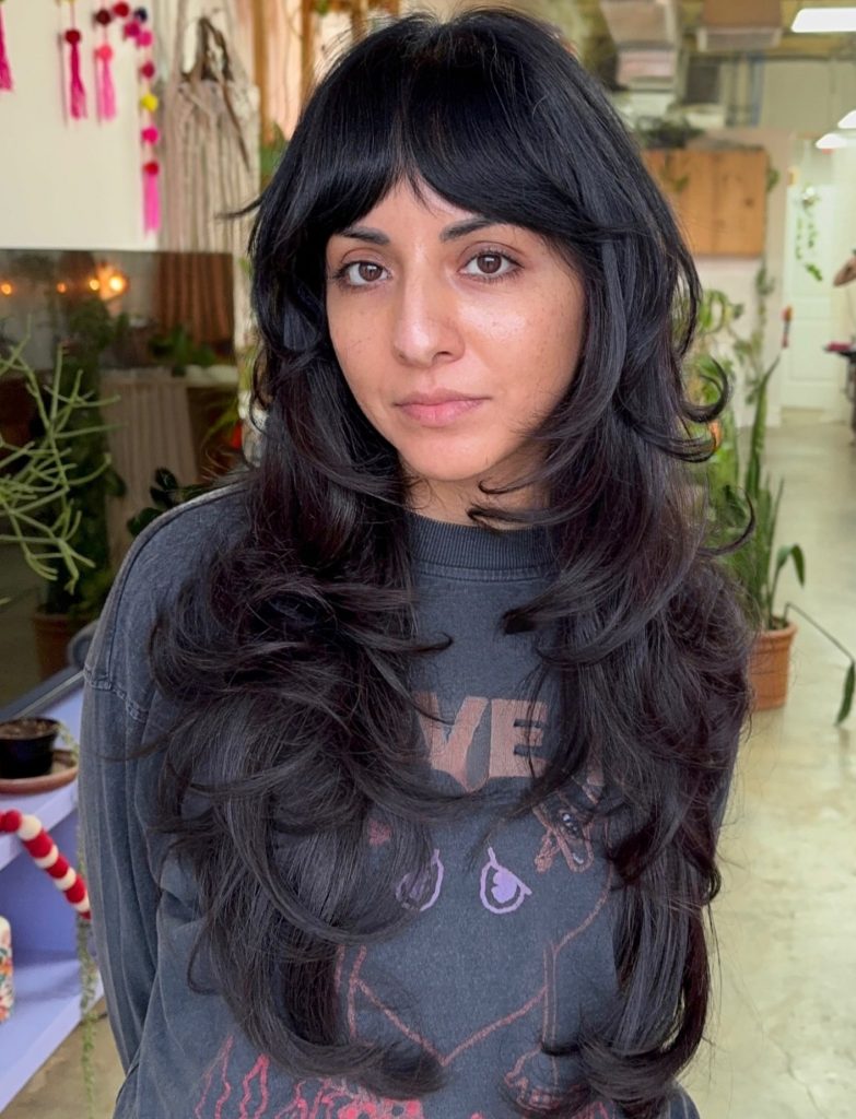 Long Shag Haircut with Feathered Layers and Curtain Bangs on Brunette Hair