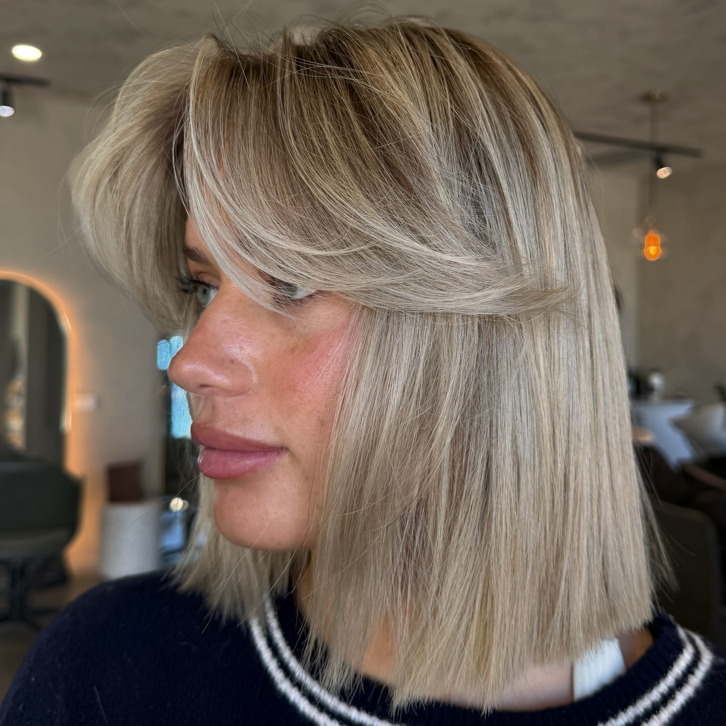 Straight Sandy Blonde Bob with Voluminous Face-Framing Layered Fringe Side View