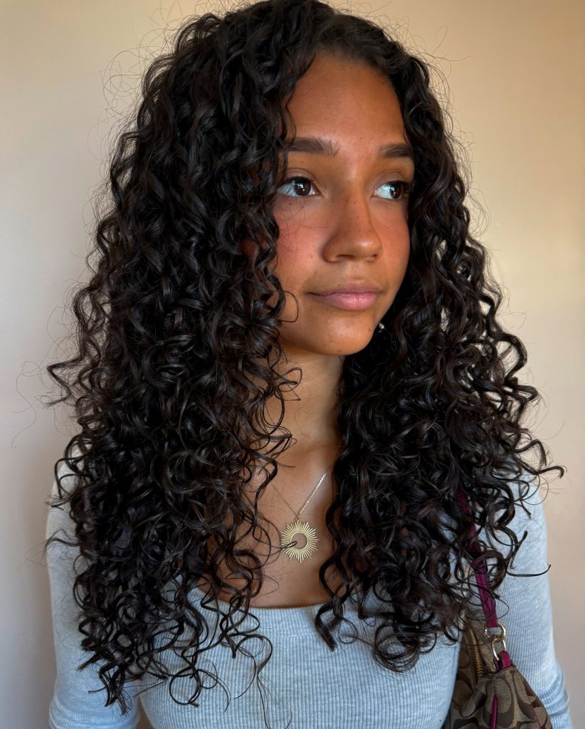 Layered Haircuts Shown on Different Hair Textures Including Curly Locks