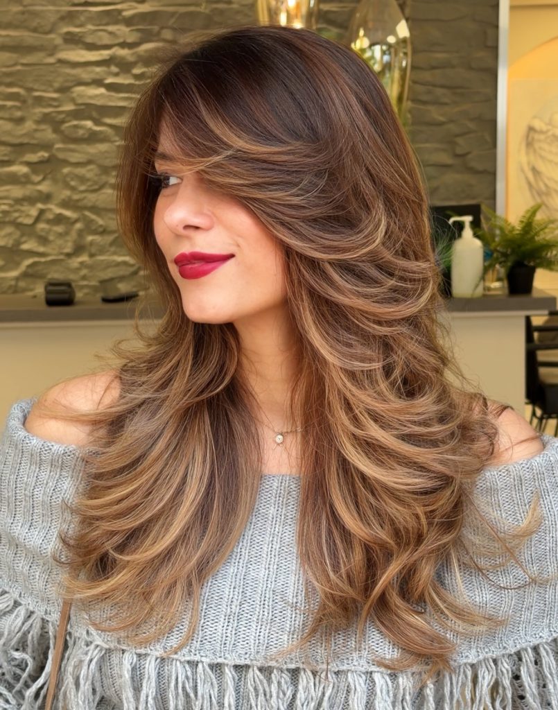 Curtain Bangs with Layered Balayage Highlights Framing the Face