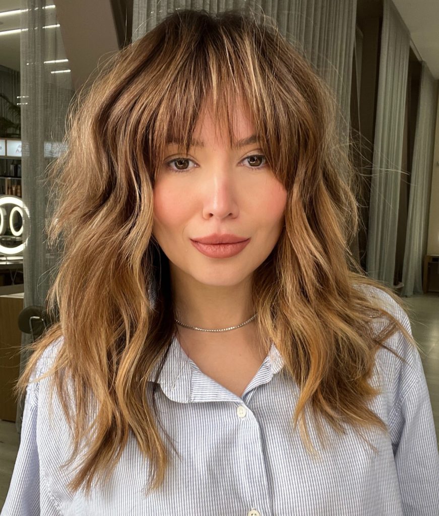 Medium Shag Haircut with Caramel Balayage Highlights Showing Color Dimension