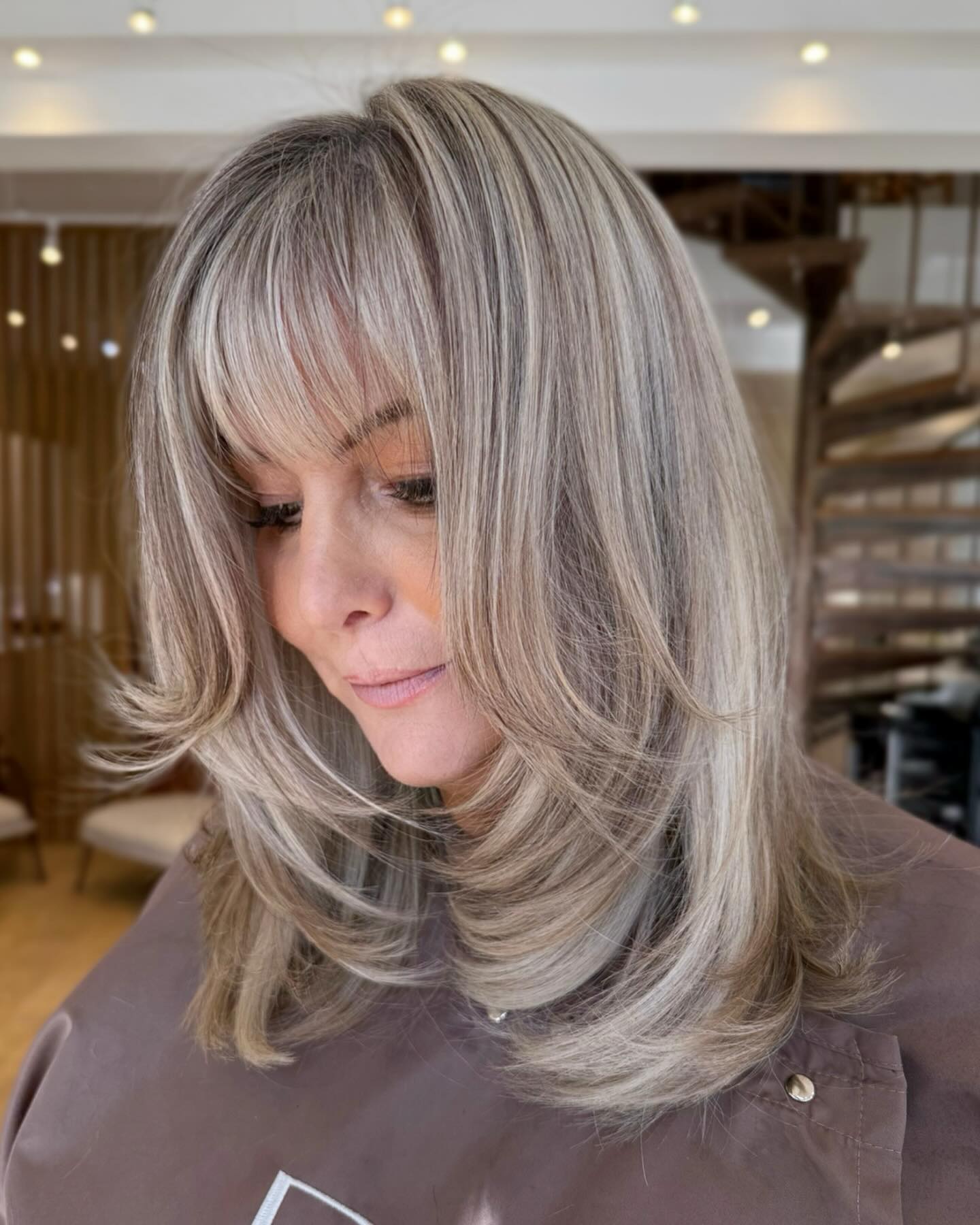 Sleek Layered Ash Blonde Hairstyle with Bangs