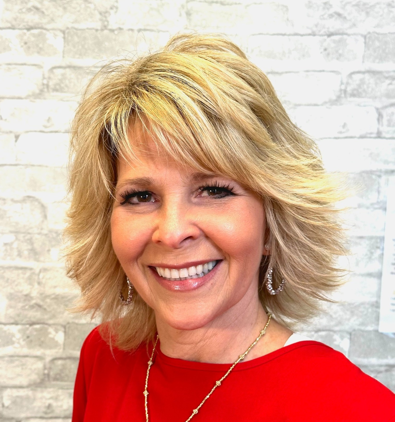 Voluminous Shaggy Blonde Hairstyle with Bangs