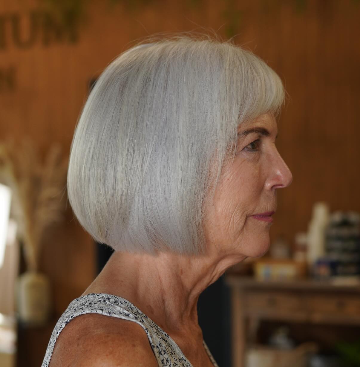 Side Profile of a Classic Straight Silver Bob with Bangs