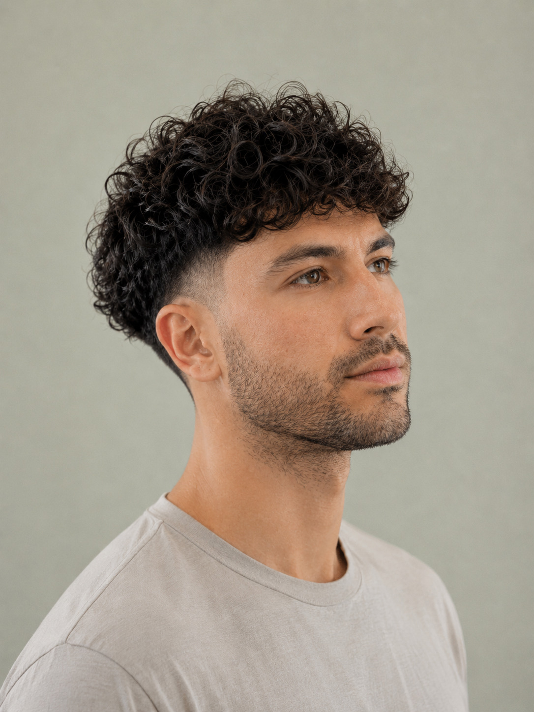 Defined Curly Top With Rounded Shape And Mid Taper Fade