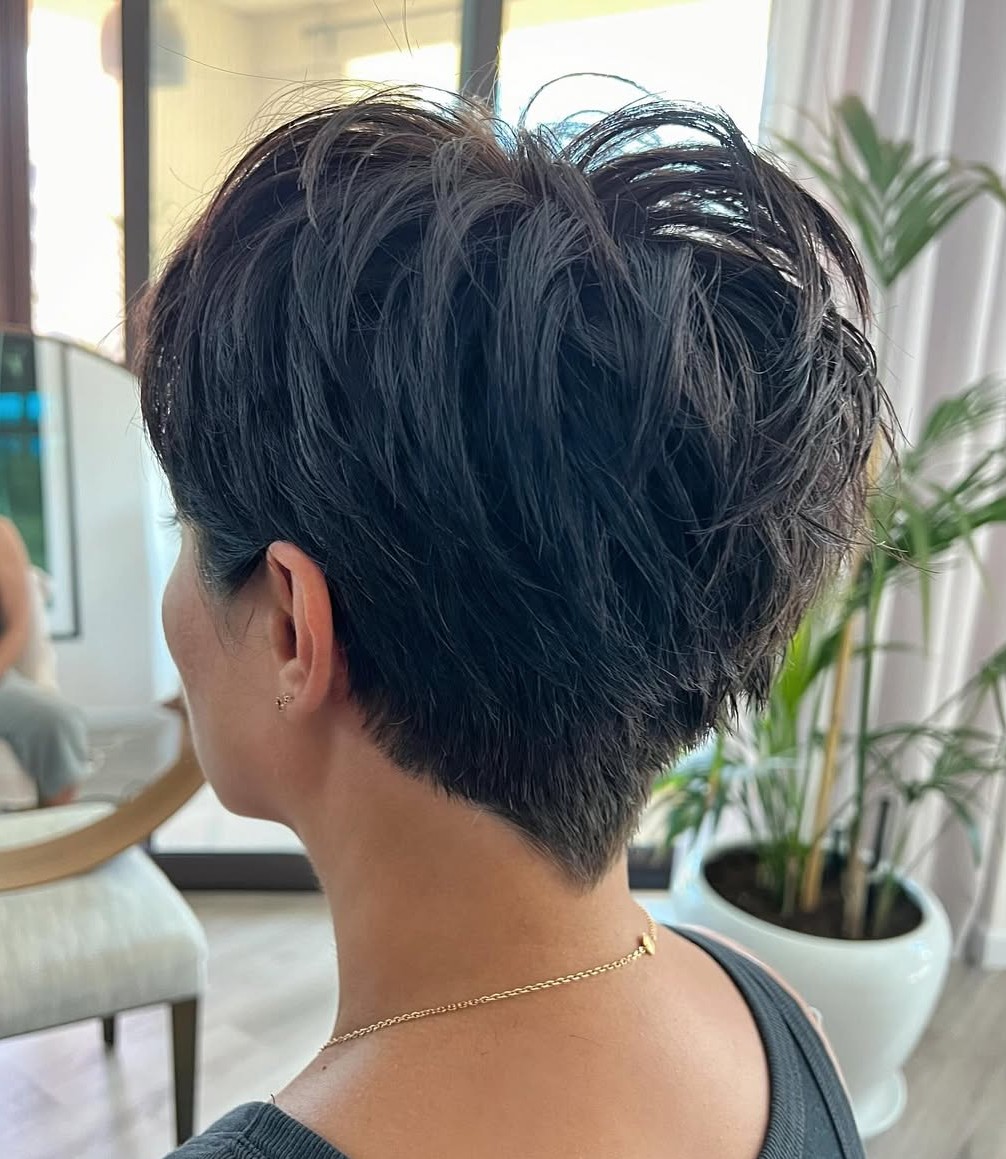 Back View of a Short Textured Jet Black Pixie Cut with Tapered Neckline