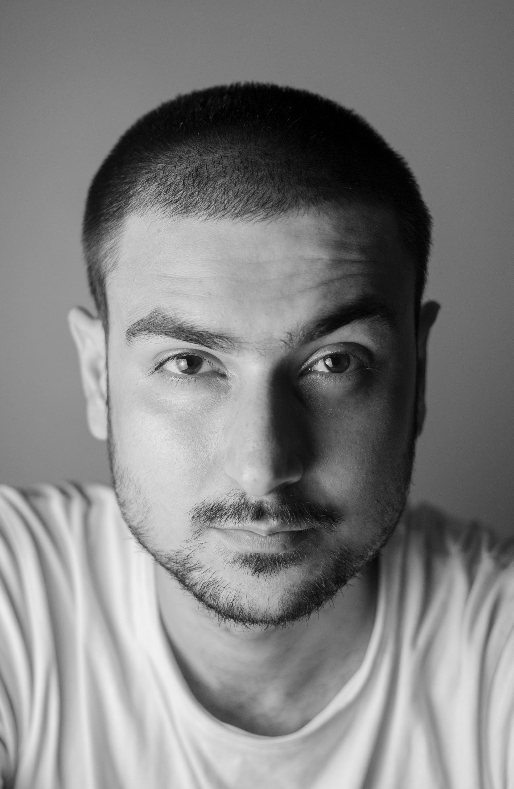 4 Guard Buzz Cut at Half-Inch Length with Even Coverage on Dark Hair