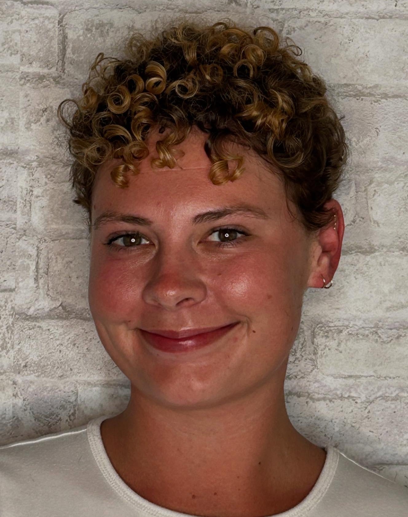 Color-Enhanced Curly Pixie with Honey Balayage Highlights on Medium Brown Curls