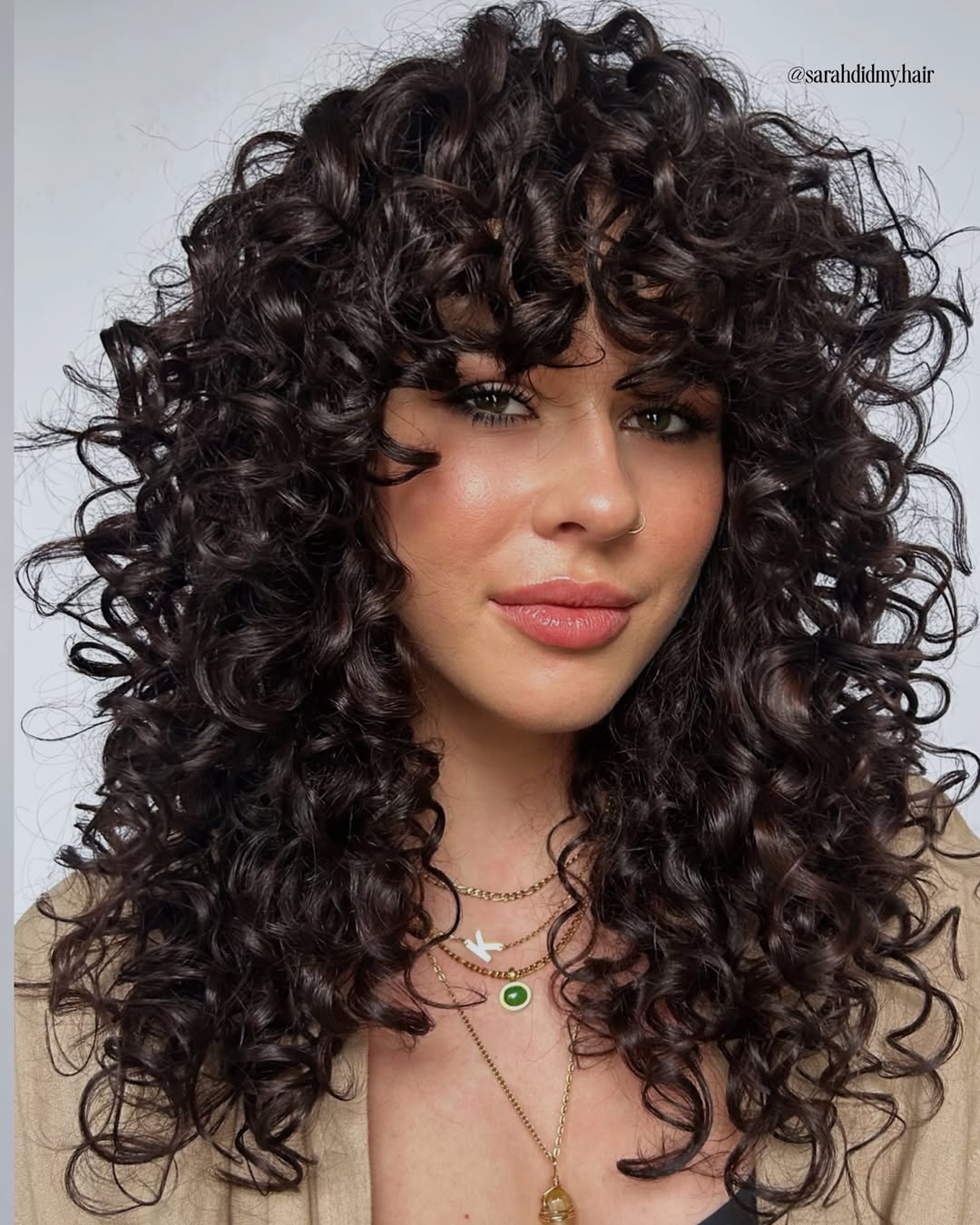 Thick Dark Curly Shaggy Haircut with Full Voluminous Curly Fringe