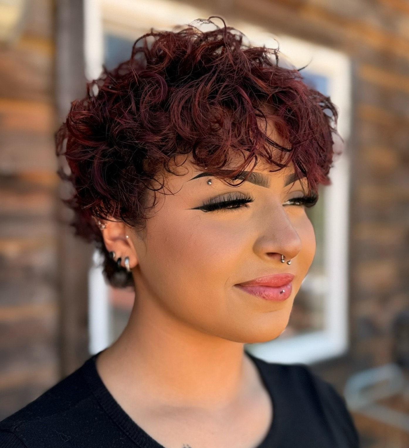 Face-Flattering Curly Pixie Cut with Volume at the Crown on a Round Face