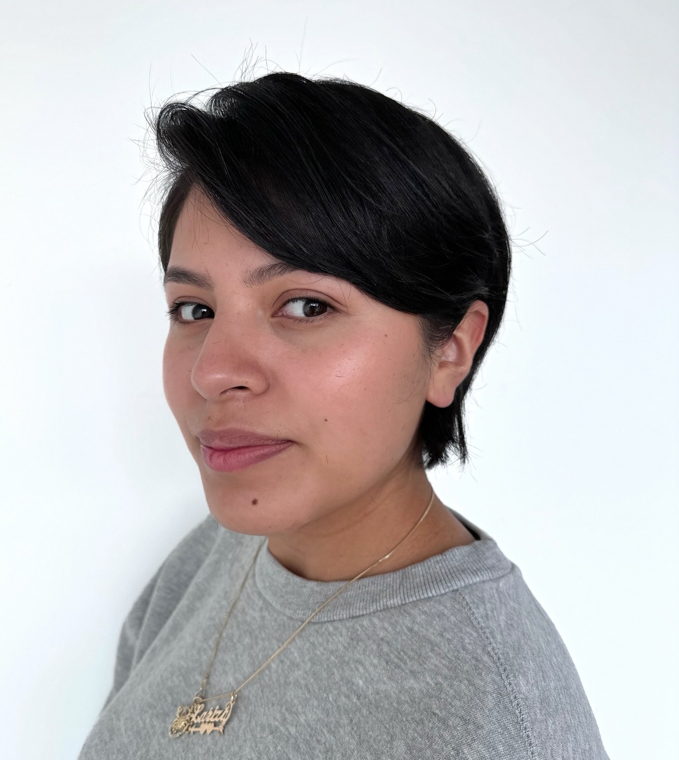 Textured Pixie on Thick Hair with Side-Swept Fringe Framing Face in Natural Light