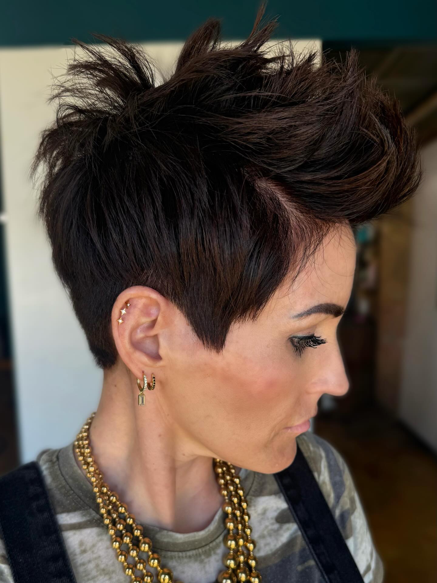 Discussing a Pixie Cut Reference Photo with a Stylist During a Salon Consultation for Thick Hair