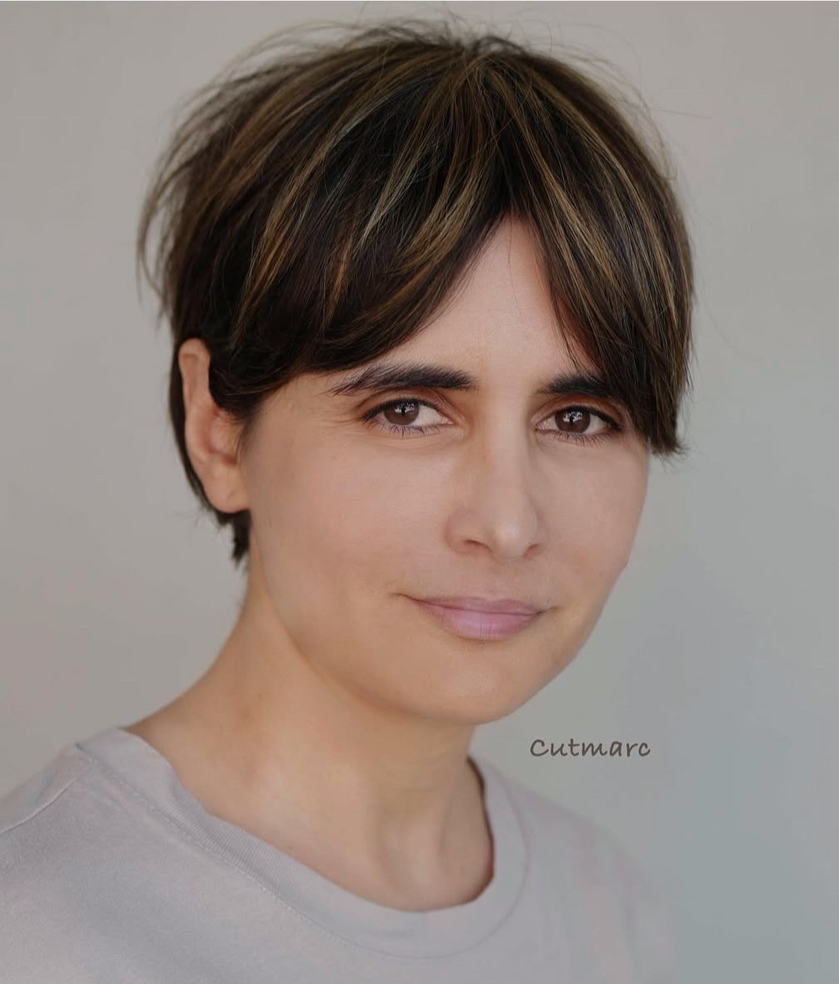 Color-Enhanced Textured Pixie with Balayage Highlights on Dark Brunette Base Showing Dimension