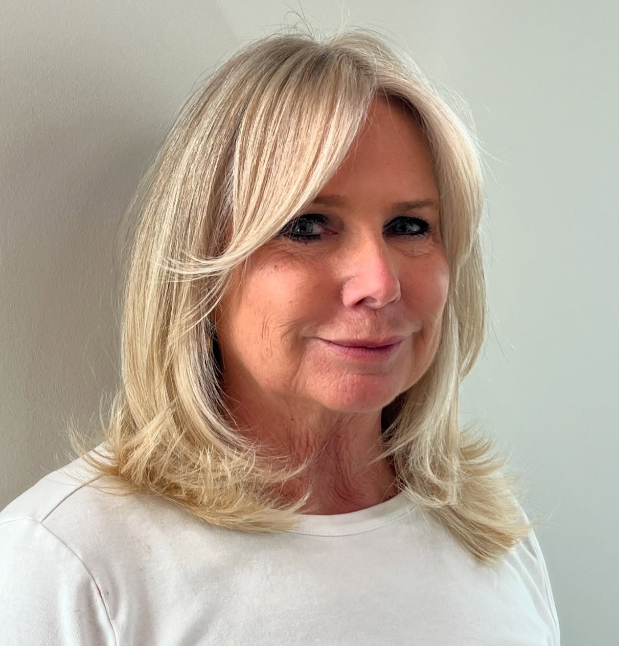 Classic Blonde Face Framing Medium Haircut for Women Over 50