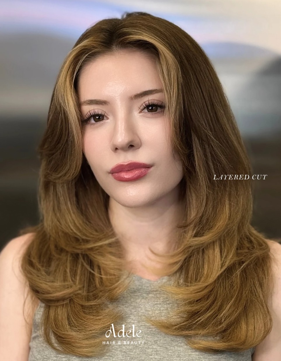 Honey Blonde Layered Haircut with Smooth C-Shape Curved Layers and Center Part