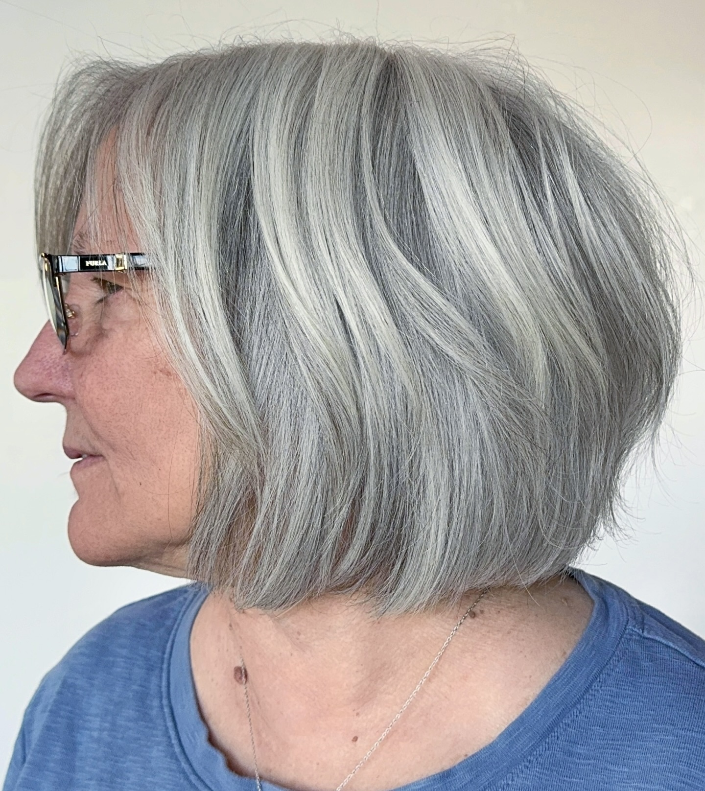Side Profile of a Layered Straight Grey Bob for Women with Glasses