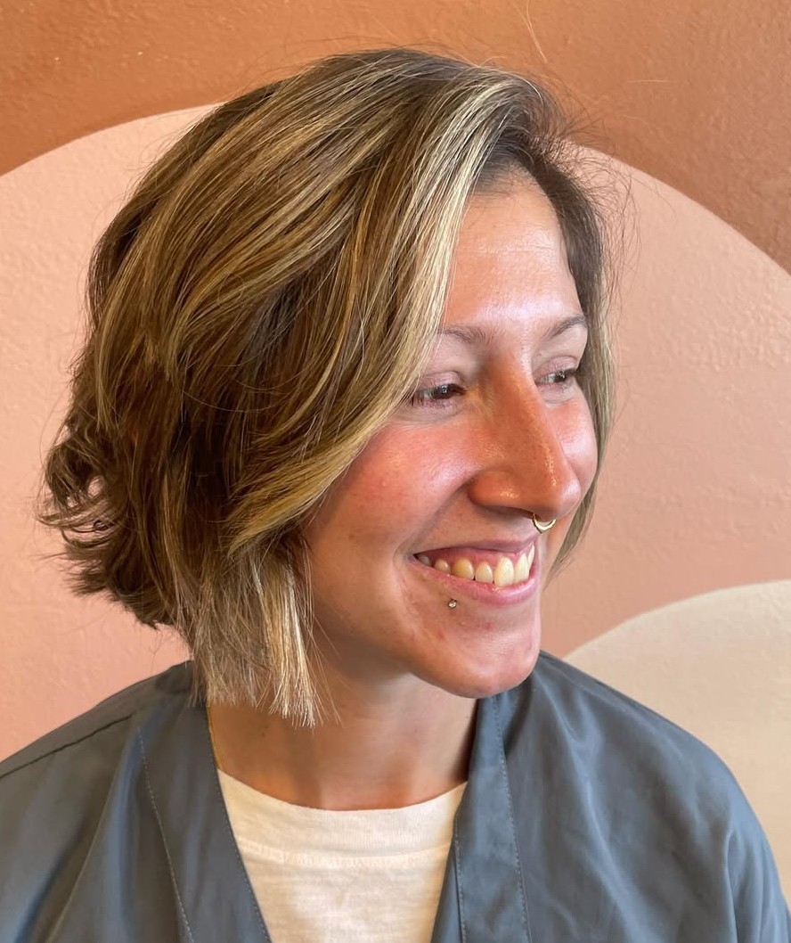 Side View of a Short Layered Blonde Bob with Dimension Highlights and Stacked Back