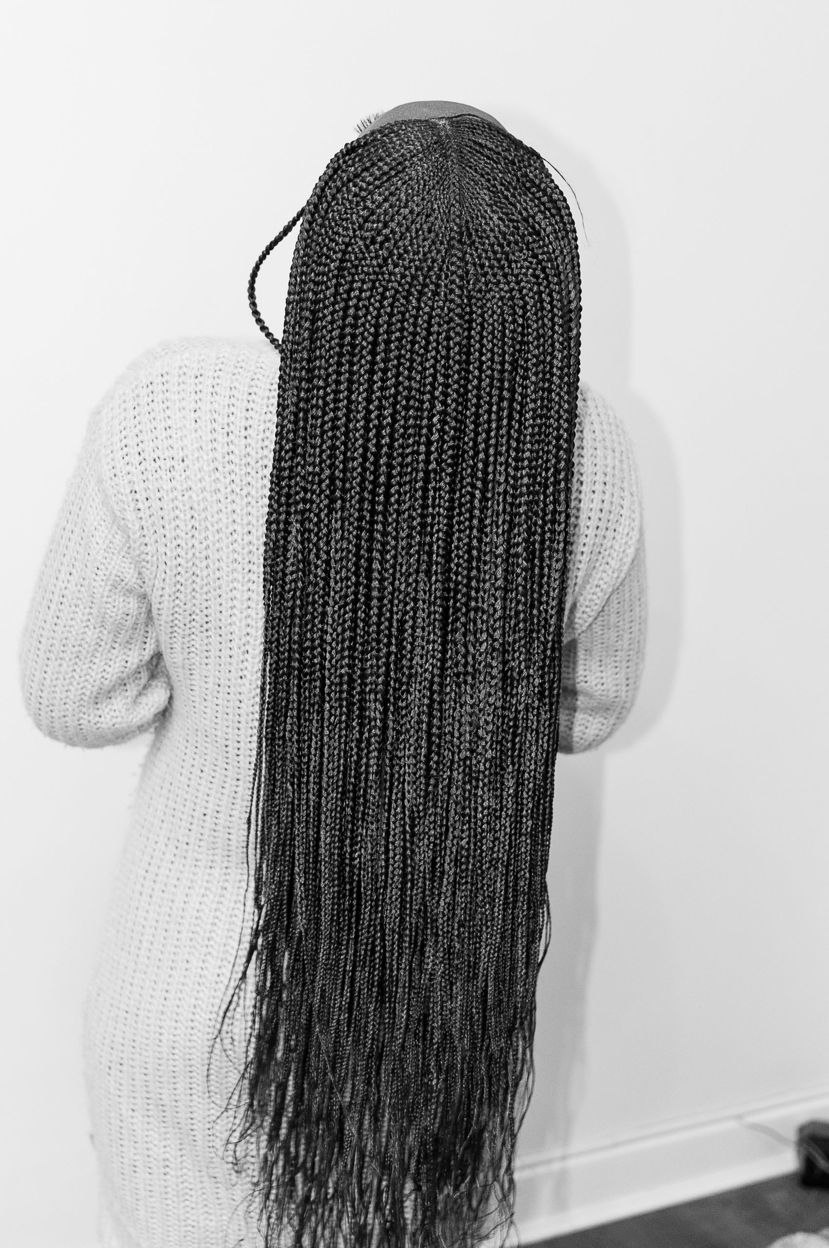 Braids for Black Women in a Mid-Back Length Knotless Style with a Clean Center Part on Natural Hair