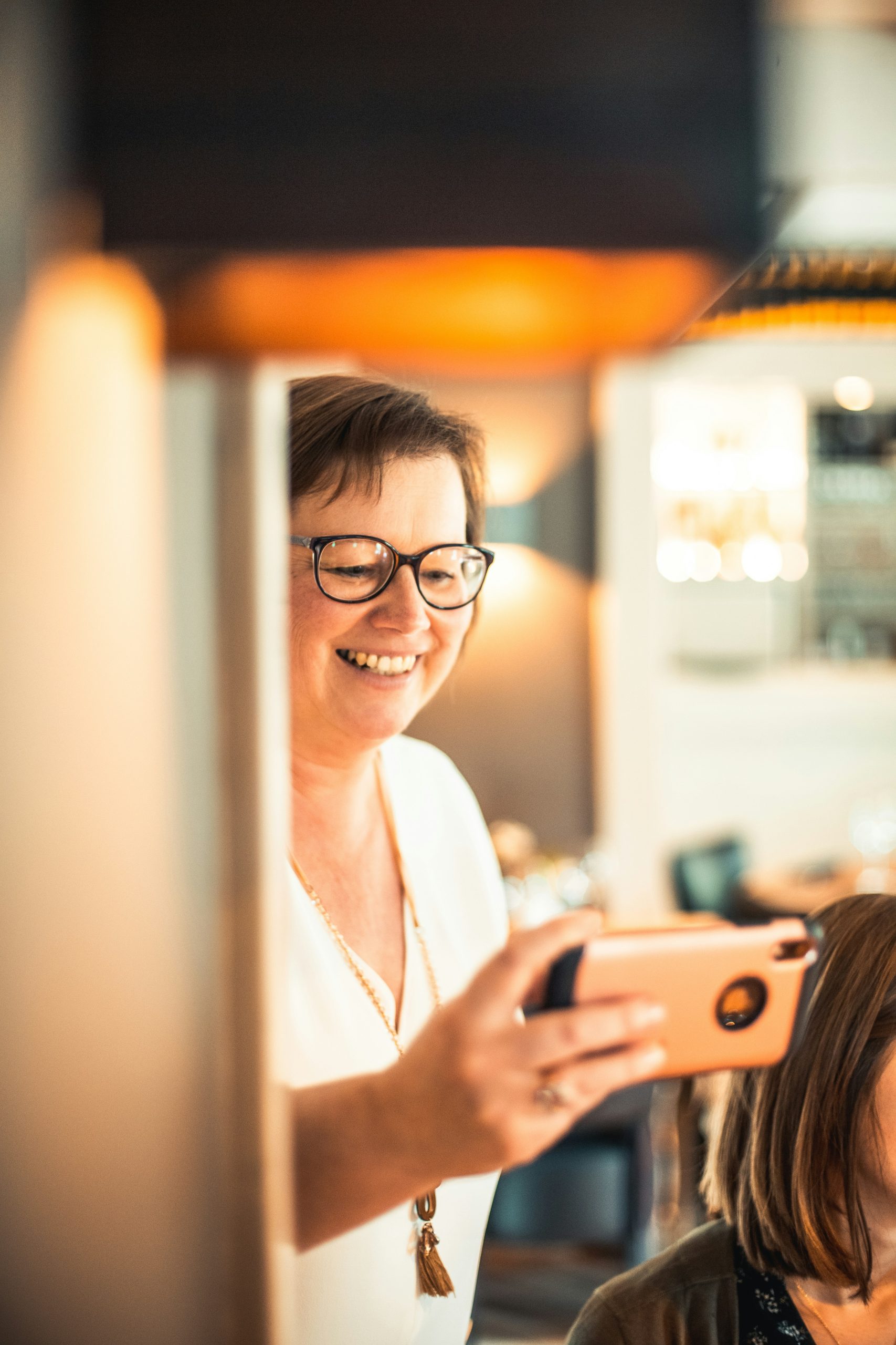 Gemini AI Hairstyle Generator Woman Using Gemini AI on Smartphone to Preview a New Hairstyle Before a Salon Visit