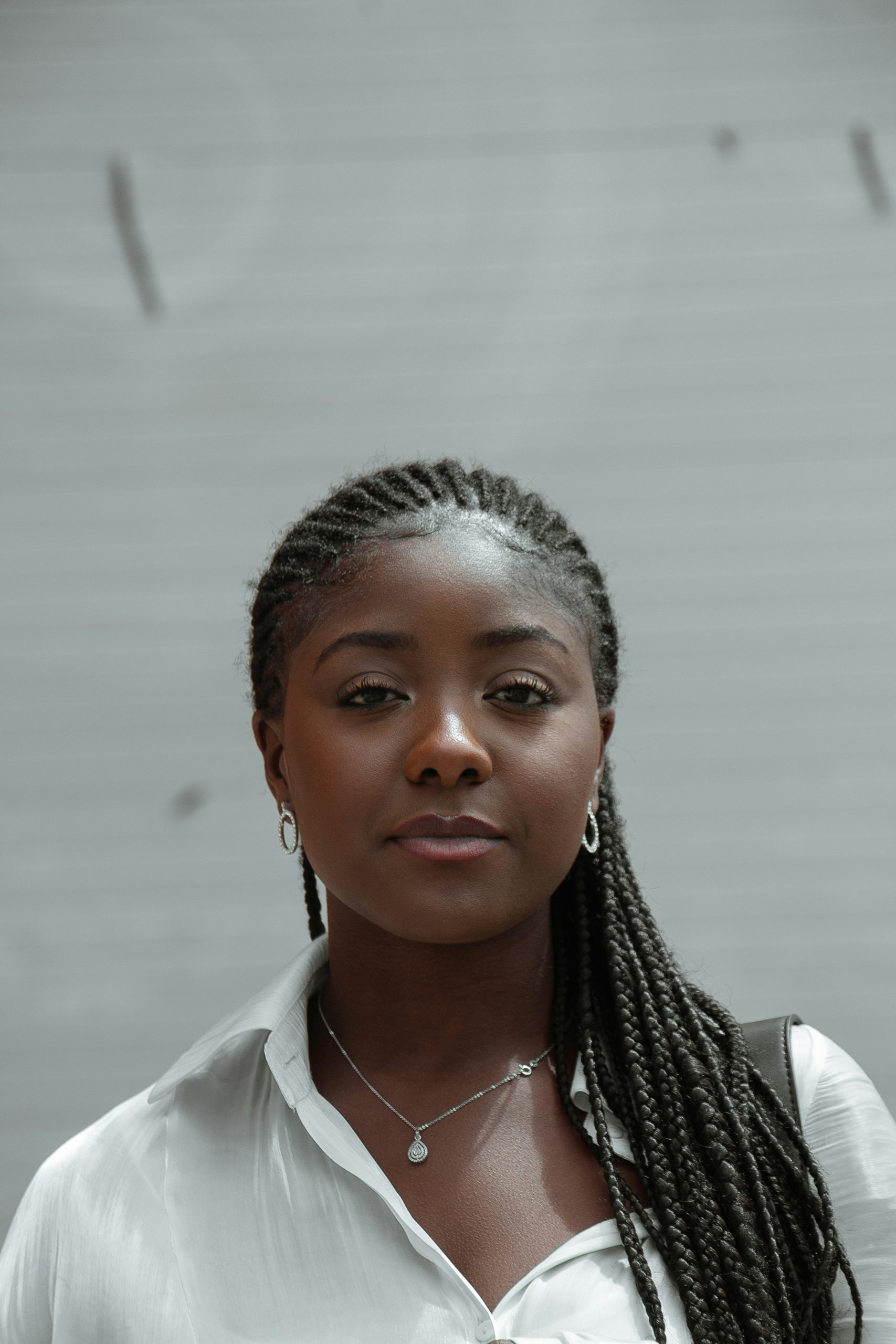 Knotless Braids with Curly Ends in a Mid-Back Length with Loose Spiral Curls Left Out at the Bottom on Natural Black Hair