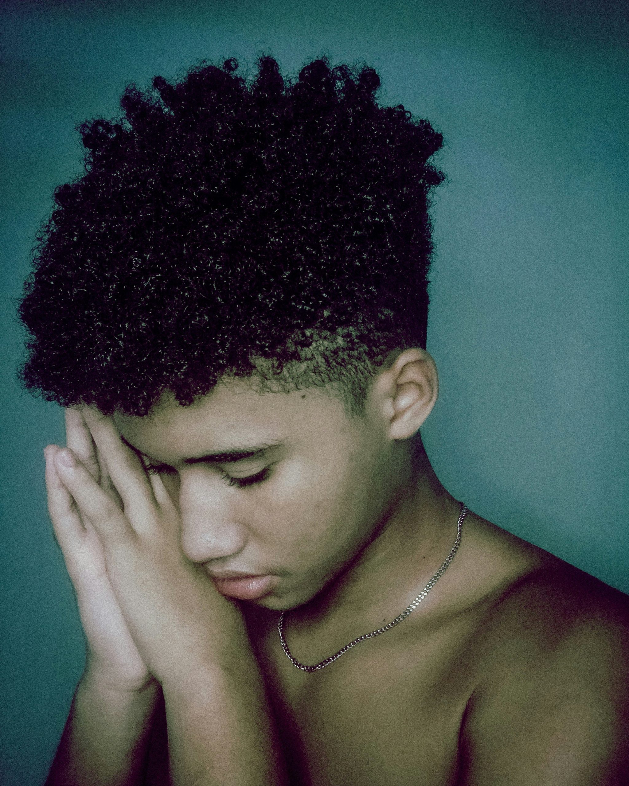 Low Taper Fade on Curly Hair with Defined Coils on Top and a Clean Soft Fade Around the Ears and Neckline